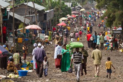People walking down crowded street in a village