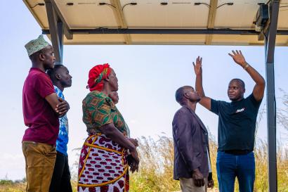 People standing under solar roof