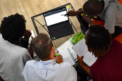 Overhead view of people looking at a laptop
