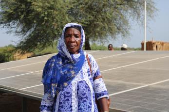 Woman standing near solar panels