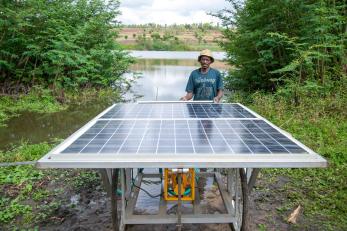 Man standing outside in front of solar panel