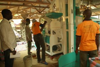 Men working with farm equipment