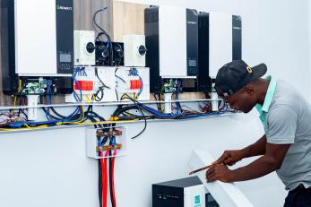 Man installing mini-grid system.