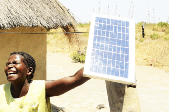 woman holding a solar panel