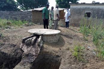 people standing near a well