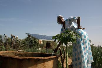 woman standing near outdoor water pump
