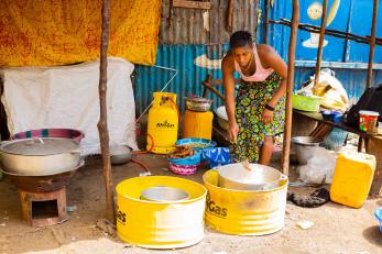 woman bending to stir pot