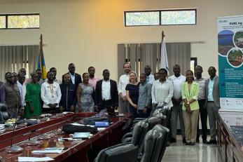 group of people standing in conference room