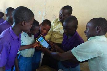 children looking at a mobile device
