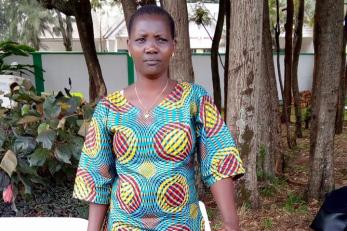 woman standing with cooking pots
