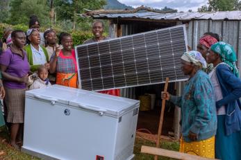 people holding a solar panel