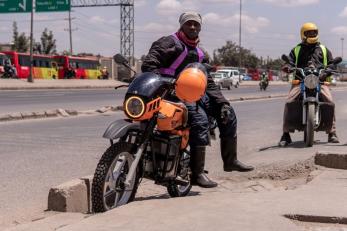 two adults on motorcycles