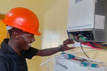 Man working on energy technology component.