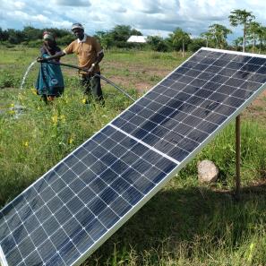 Two people in farm with solar panel