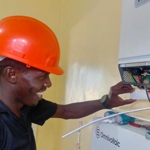 Man working on energy technology component.