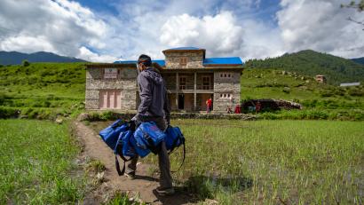 A health worker delivers COVID‑19 kits to an isolation center in Julma, a remote community in Nepal. The kits from Prosper Global include face masks and shields, hand sanitizer, thermometers, soap, and oximeters.