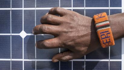Person's hand grabbing solar panel