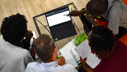 Overhead view of people looking at a laptop