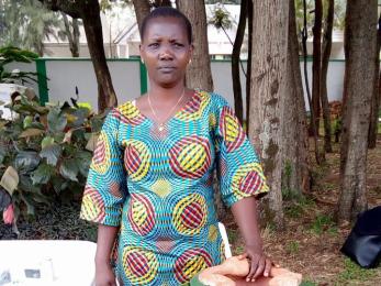 woman standing with cooking pots