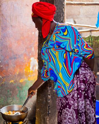 woman stirring food in cooking pot