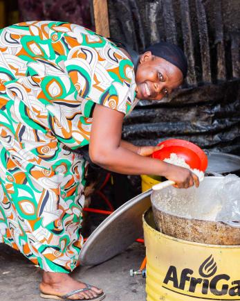 woman leaning over cooking pot