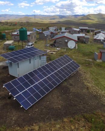 overhead view of solar panels on houses in small village