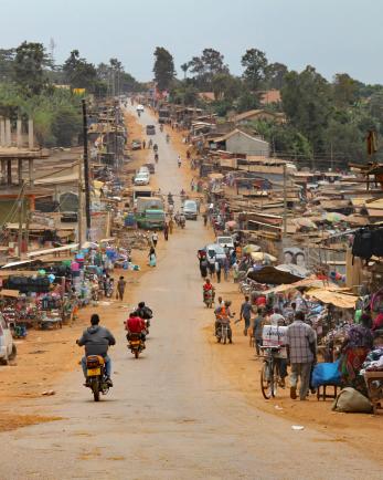 people walking down a street in a village