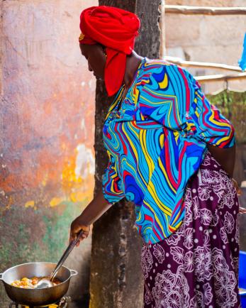 woman cooking and stirring food in pan
