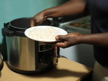 Person getting food from a pot