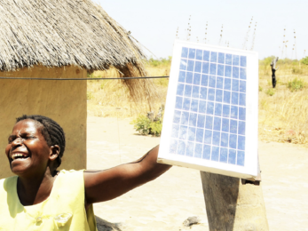 Woman holding a solar panel