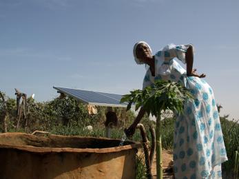 Woman standing near outdoor water pump