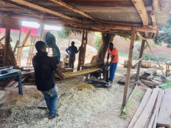 Several men in a lumber yard