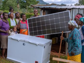 People holding a solar panel