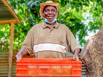 An avocado farmer holding a basket.